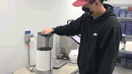 A man putting the tank of the Honeywell HUL430 into place