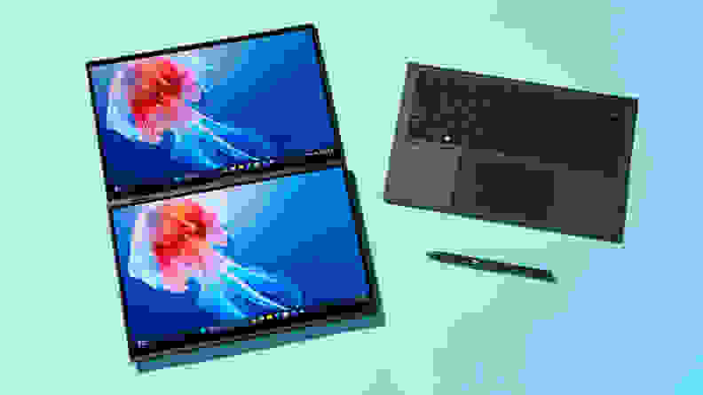 Dual screens of the 2024 Asus Zenbook Duo laptop sitting next to keyboard and stylus pen.