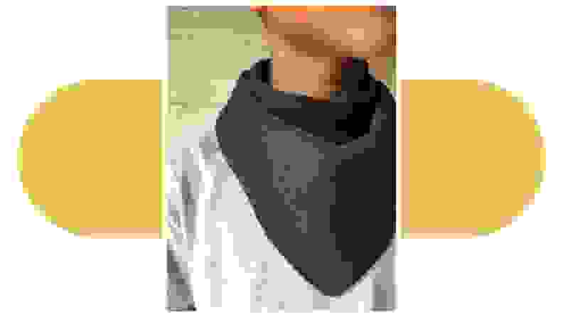 Close-up of a person wearing a green Droolist bib around their neck.
