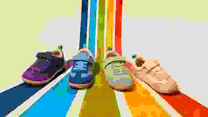 4 colors of retro suede sneakers on rainbow lines corresponding to the shoe color (purple, blue, green, pink)