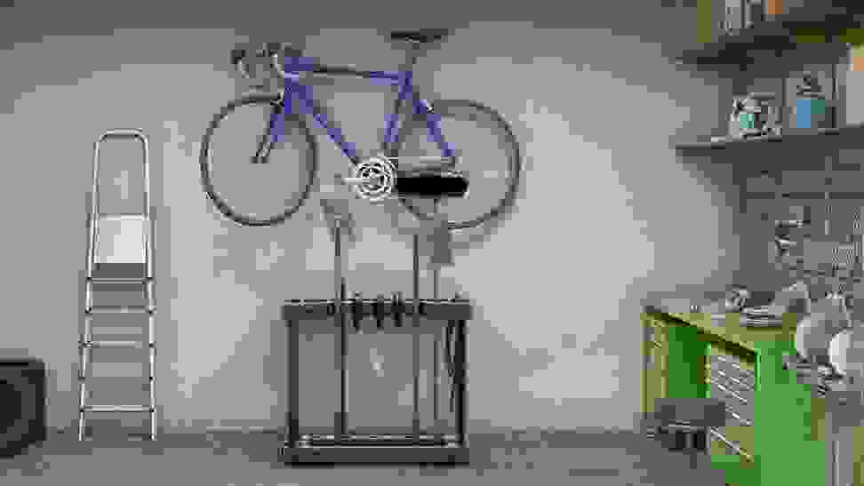 Garden tools and a bike hanging from an organizer.