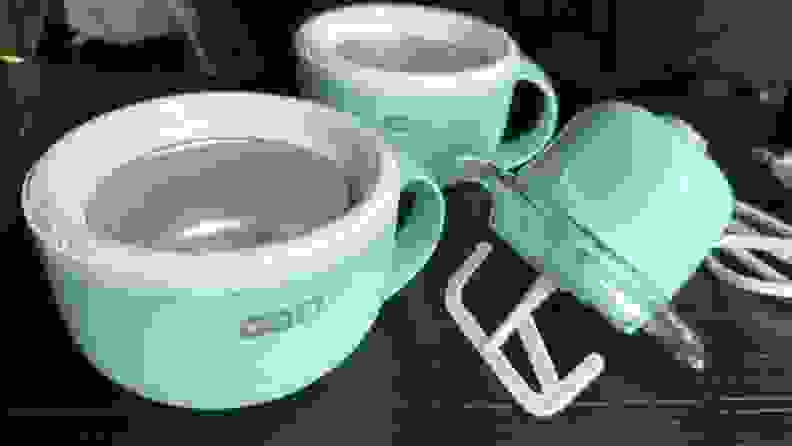 The Dash ice cream maker mug bases and motorized head on wooden surface.