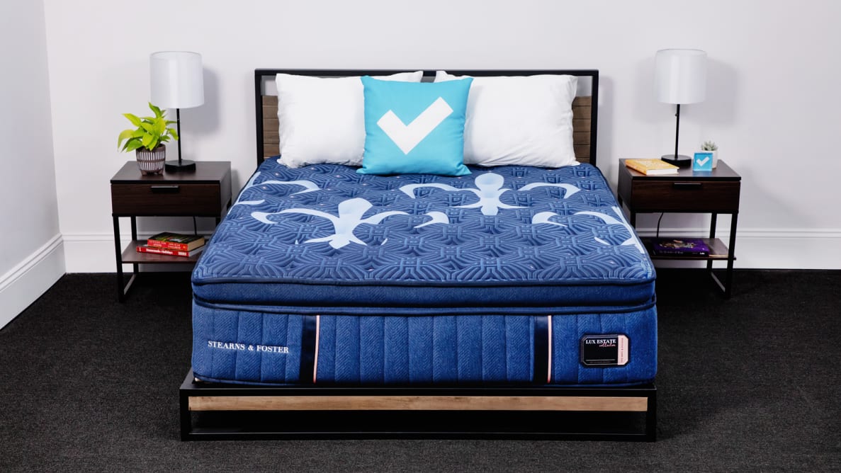 The Stearns & Foster  Lux Estate Pillow Top mattress in a bedroom between two bedside tables.