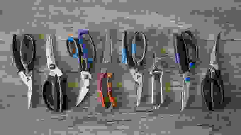 Eight sets of poultry shears on wooden surface