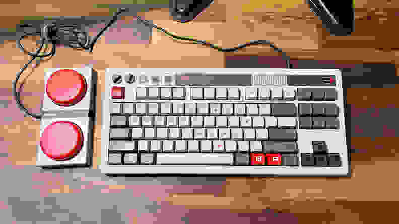 A grey retro keyboard with two large red buttons, the best budget gaming keyboard on the market