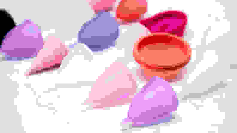 menstrual cups on white marble background