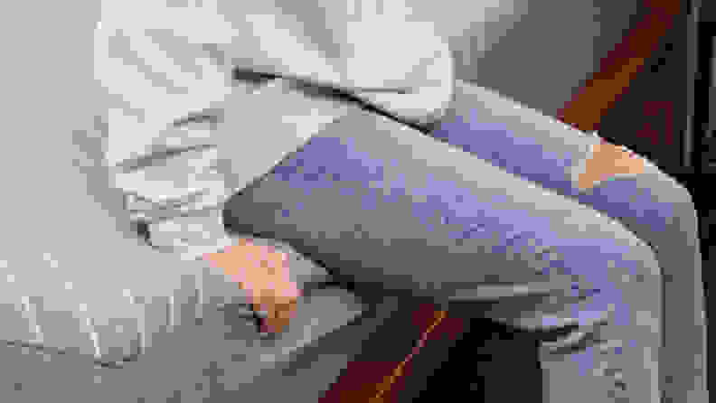 A person sitting on the edge of the Siena Memory Foam mattress.