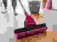 Woman cleaning a floor with a mop and bucket