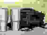 An Ozark Trail tumbler and a Yeti rambler sitting on a table.