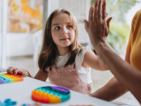 Child giving a high-five to a adult