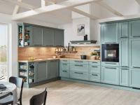 A beautiful, sunny kitchen with two walls of cabinets painted green