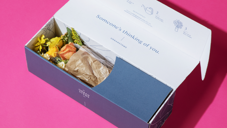 A bouquet of flowers in a cardboard box.