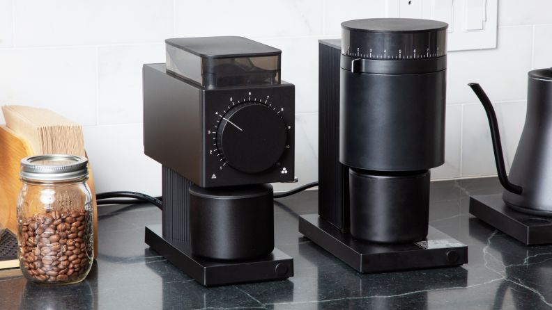 Fellow Ode & Opus Coffee Grinders side-by-side on top of marble counter.