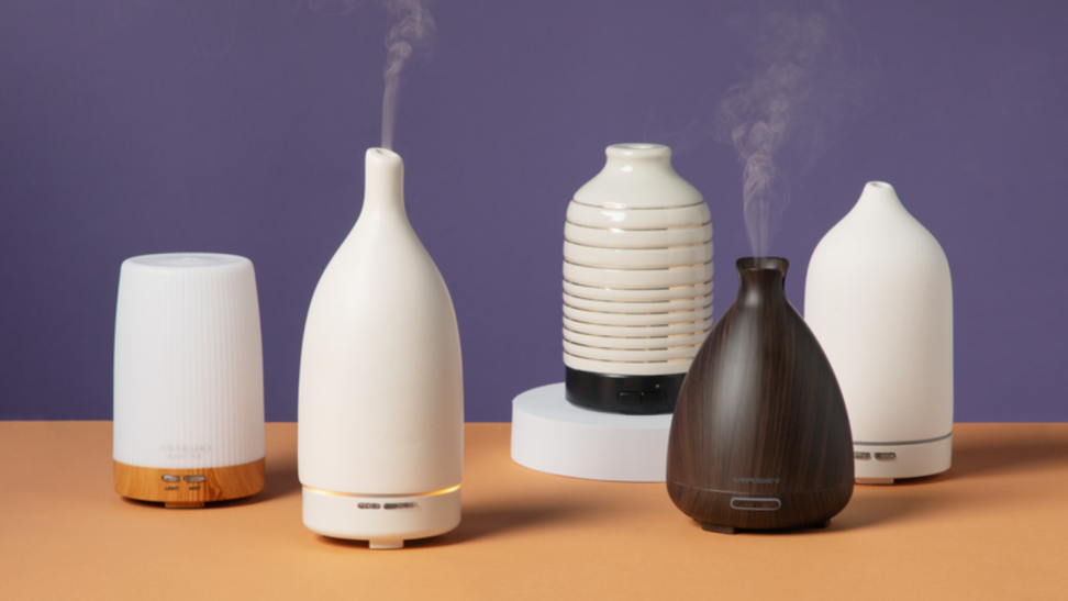 Five oil diffusers sitting on a table.