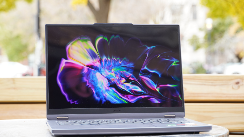 The Lenovo Legion Slim 5 14APH8 laptop open, on a desk.